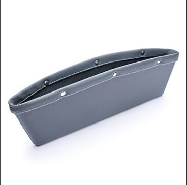 A car storage box positioned in a vehicle trunk for organizing items.