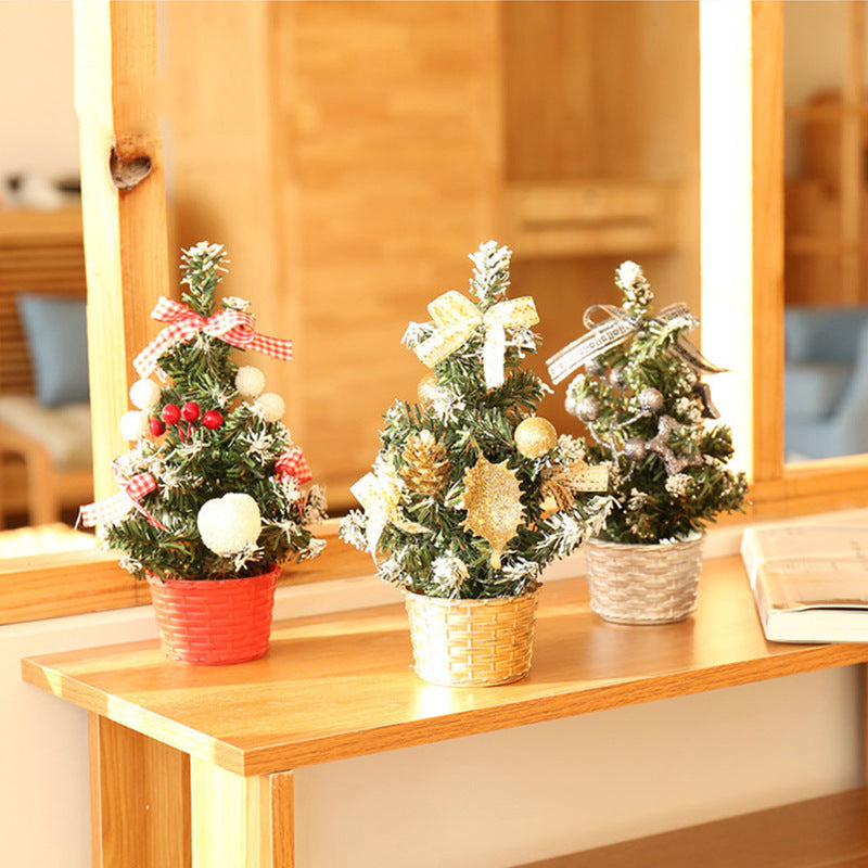 A small PVC Christmas tree decorated with built-in LED lights, displayed as a desktop ornament.