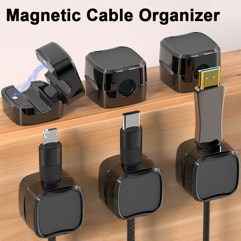 A small magnetic clip designed to hold and organize cables, shown mounted to the underside of a desk with a cord secured inside it.